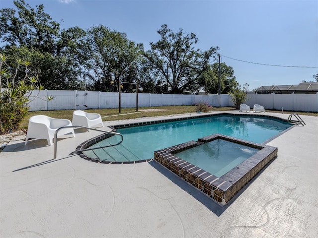 view of swimming pool with an in ground hot tub and a patio area