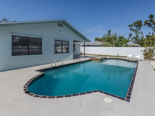 view of swimming pool with a hot tub and a patio