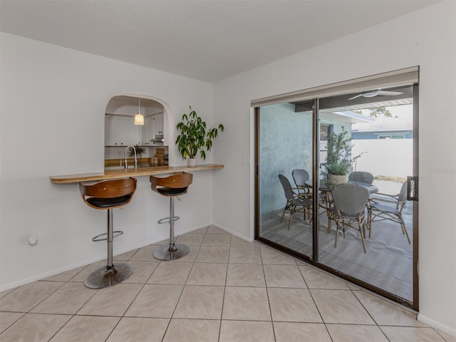 tiled dining room featuring sink