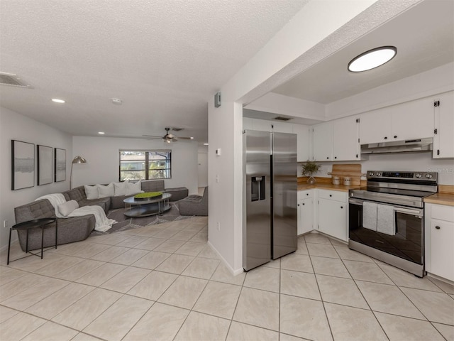 kitchen featuring white cabinetry, light tile patterned floors, a textured ceiling, and appliances with stainless steel finishes