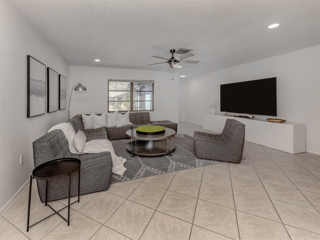 tiled living room featuring ceiling fan and a textured ceiling