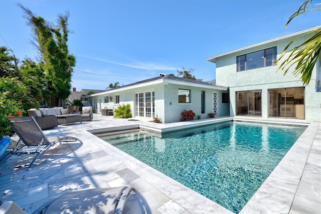 view of pool featuring a patio area, french doors, outdoor lounge area, and a fenced in pool