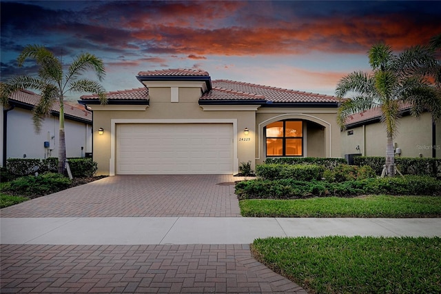 mediterranean / spanish-style home with a garage