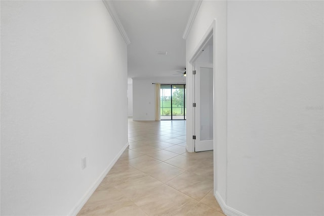 hall featuring light tile patterned floors and ornamental molding