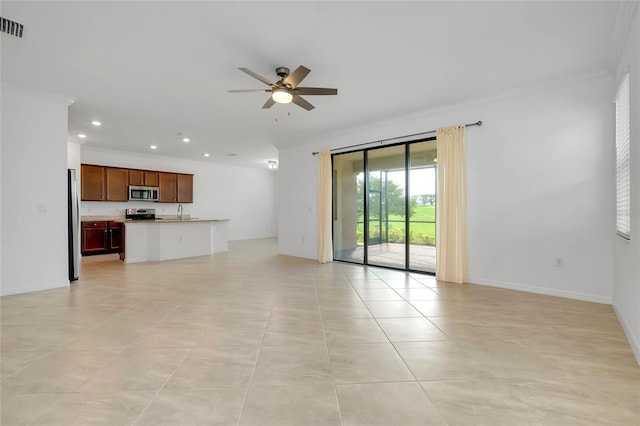 unfurnished living room with ornamental molding, sink, light tile patterned floors, and ceiling fan