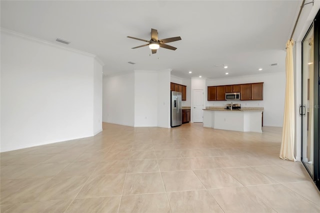 unfurnished living room with ceiling fan, ornamental molding, and light tile patterned floors