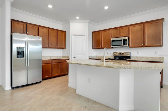 kitchen featuring appliances with stainless steel finishes, sink, ornamental molding, a kitchen island with sink, and light stone counters