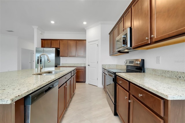 kitchen with sink, light stone counters, crown molding, an island with sink, and stainless steel appliances