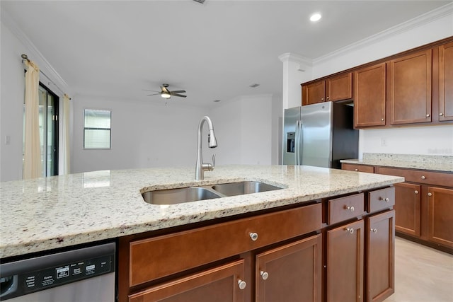 kitchen with light stone countertops, stainless steel appliances, and sink