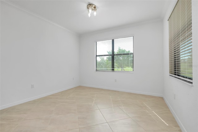 unfurnished room with ornamental molding and light tile patterned floors