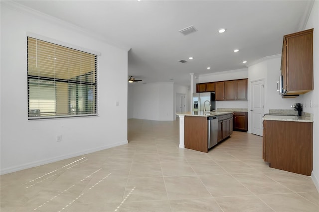 kitchen featuring a center island with sink, light tile patterned floors, ornamental molding, ceiling fan, and stainless steel appliances