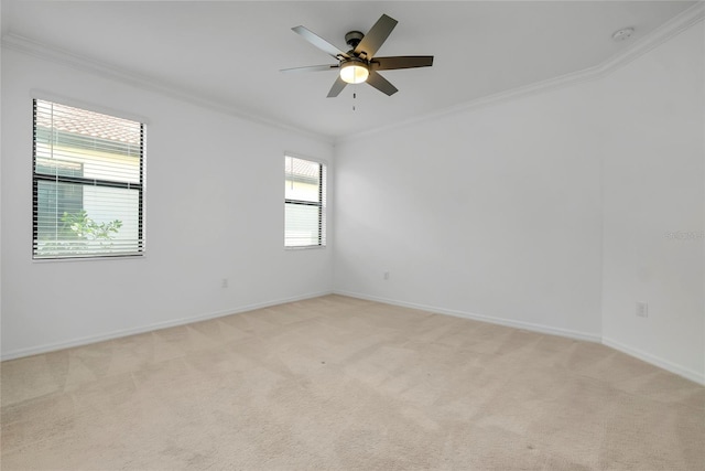 carpeted spare room with crown molding and ceiling fan