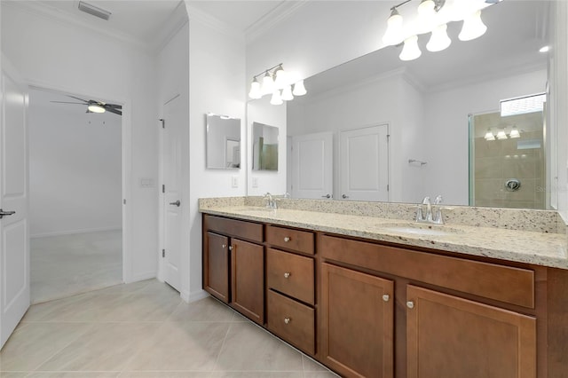 bathroom featuring tiled shower, crown molding, vanity, ceiling fan, and tile patterned flooring