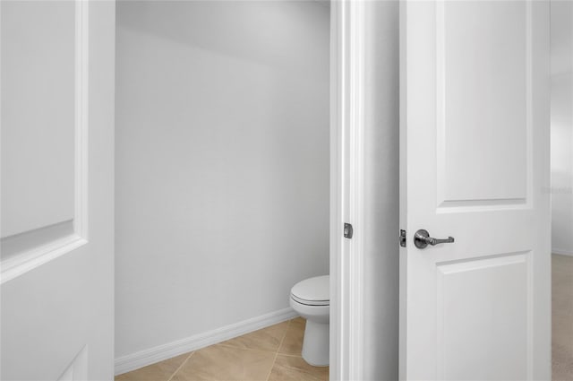 bathroom featuring toilet and tile patterned flooring