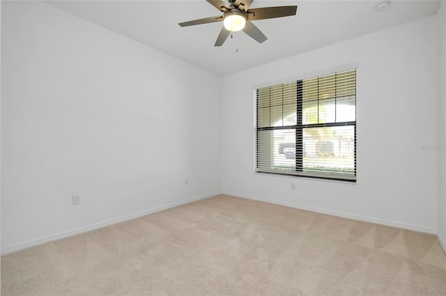 unfurnished room with ceiling fan and light colored carpet