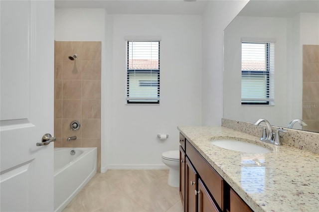 full bathroom featuring tiled shower / bath, a healthy amount of sunlight, toilet, and vanity