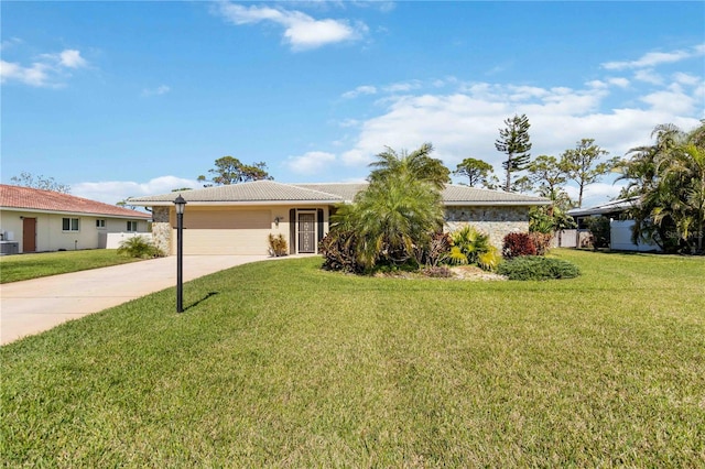 single story home featuring a front lawn, a tile roof, stone siding, concrete driveway, and an attached garage