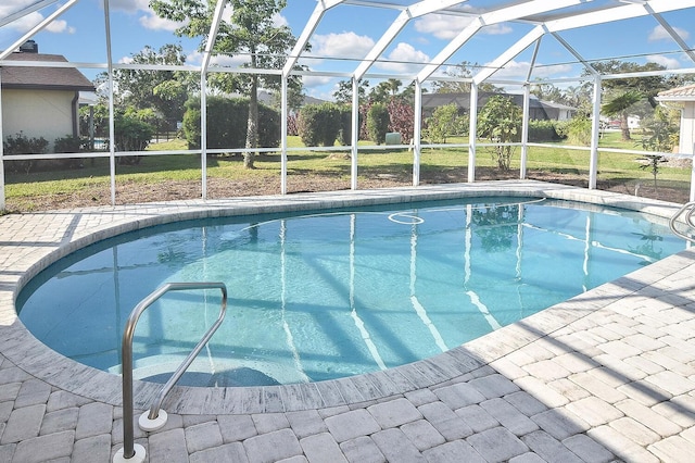 view of pool with a lanai and a lawn