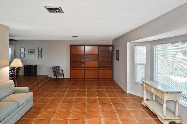 tiled living room with a textured ceiling