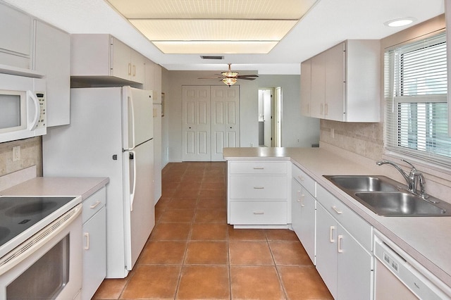 kitchen featuring sink, white cabinetry, ceiling fan, dark tile patterned floors, and white appliances