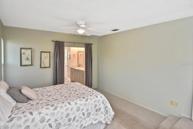 carpeted bedroom featuring ceiling fan and a textured ceiling