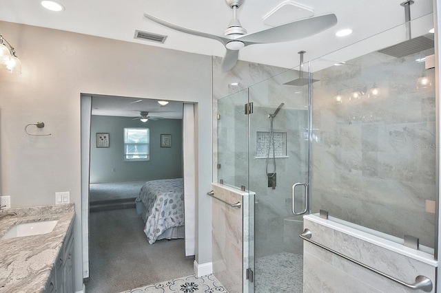 bathroom featuring ceiling fan, vanity, and an enclosed shower