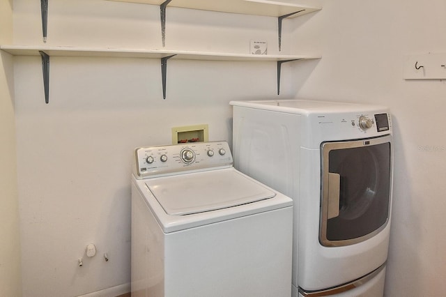 laundry room featuring washing machine and clothes dryer