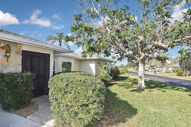 view of side of home with a lawn