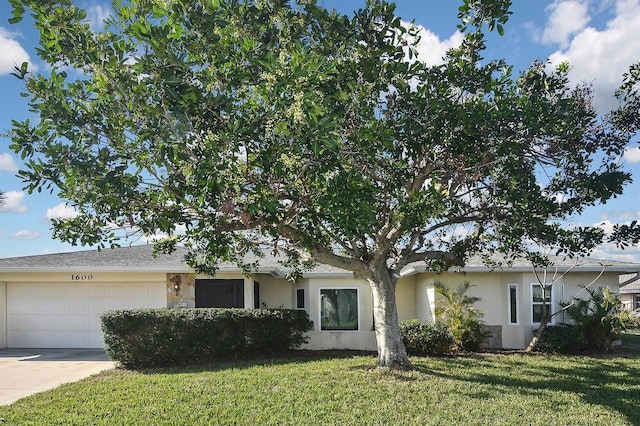 view of front of home with concrete driveway, an attached garage, a front lawn, and stucco siding