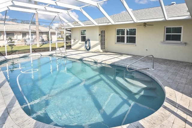 view of pool featuring ceiling fan, a patio, and glass enclosure