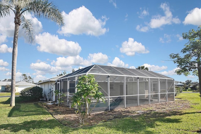 view of property exterior with a lanai and a lawn