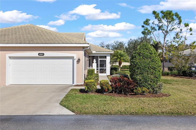 view of front of home with a garage and a front lawn