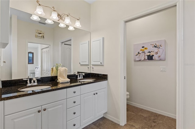 bathroom featuring vanity, toilet, and tile patterned flooring