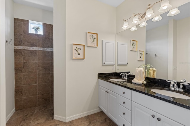 bathroom featuring vanity, tile patterned flooring, and tiled shower