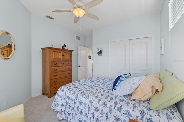 bedroom featuring light carpet, a closet, and ceiling fan