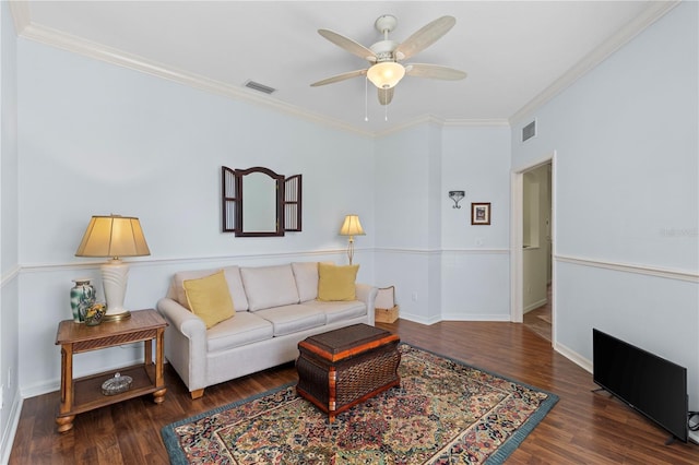 living room featuring ceiling fan, ornamental molding, and dark hardwood / wood-style flooring