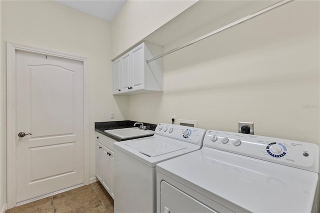 washroom with independent washer and dryer, cabinet space, and a sink