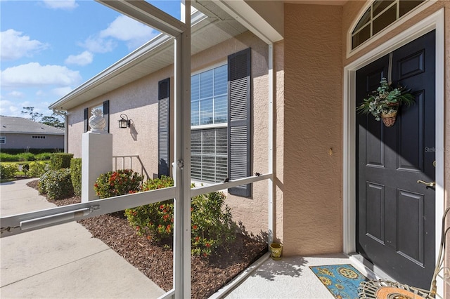 entrance to property with stucco siding