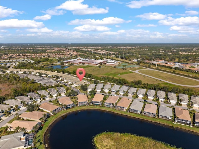 drone / aerial view featuring a residential view and a water view