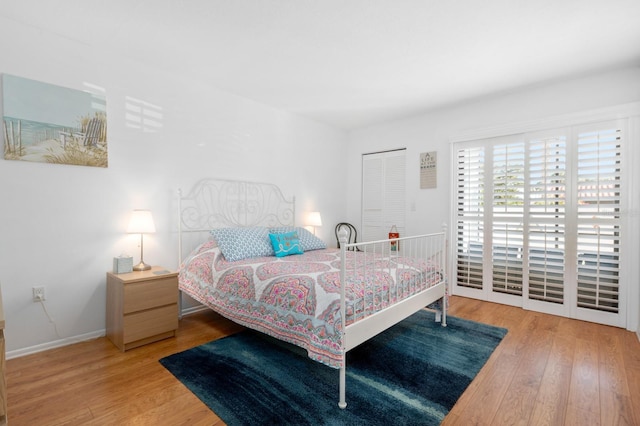 bedroom with access to exterior and light wood-type flooring