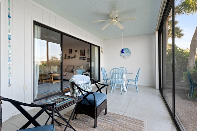 sunroom / solarium featuring ceiling fan