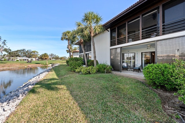 view of yard with a patio area and a water view