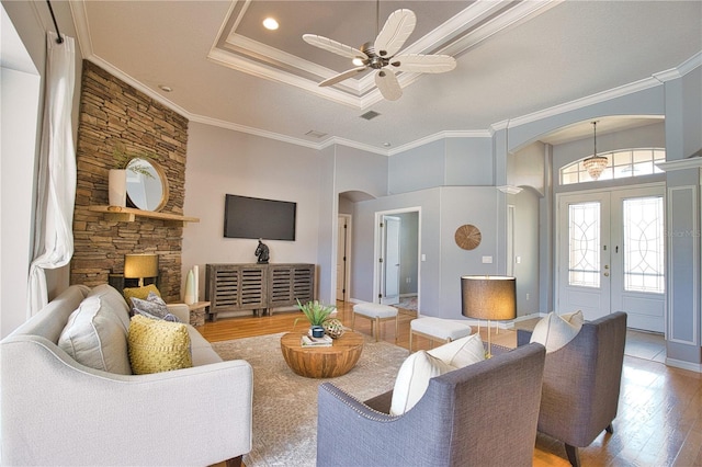 living room featuring crown molding, ceiling fan, hardwood / wood-style floors, and french doors