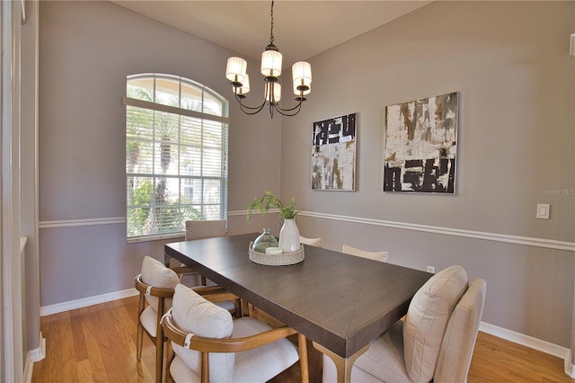 dining room featuring light hardwood / wood-style flooring and a notable chandelier