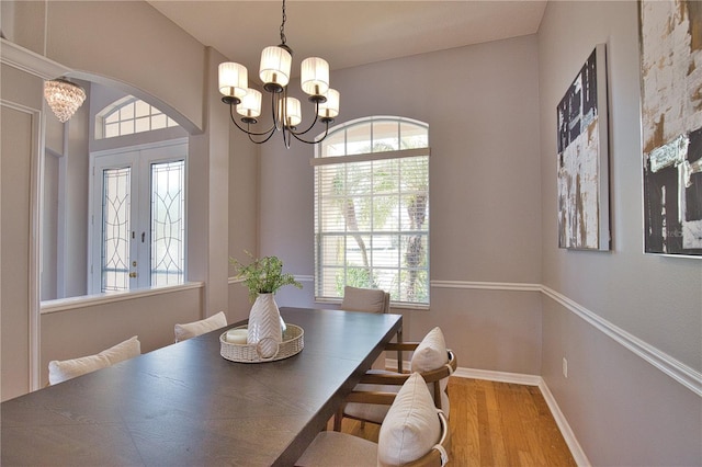 dining space featuring a wealth of natural light, a chandelier, and light hardwood / wood-style flooring