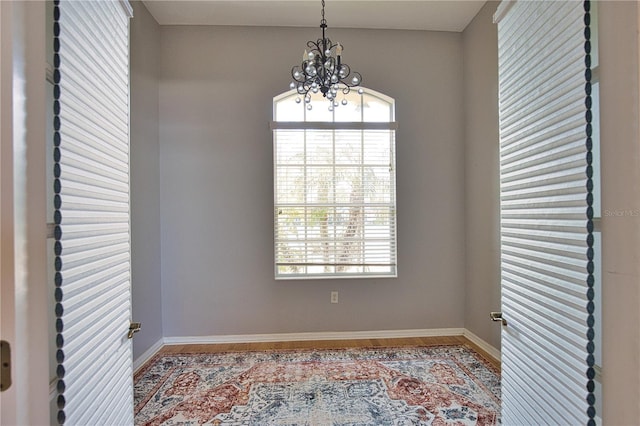 empty room featuring an inviting chandelier