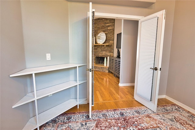 hallway with hardwood / wood-style floors