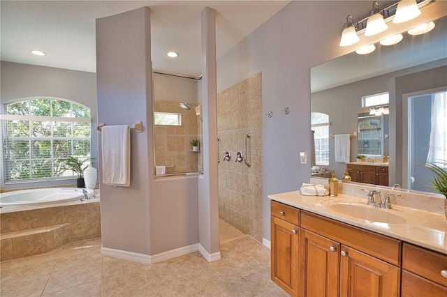 bathroom with vanity, tile patterned floors, and shower with separate bathtub