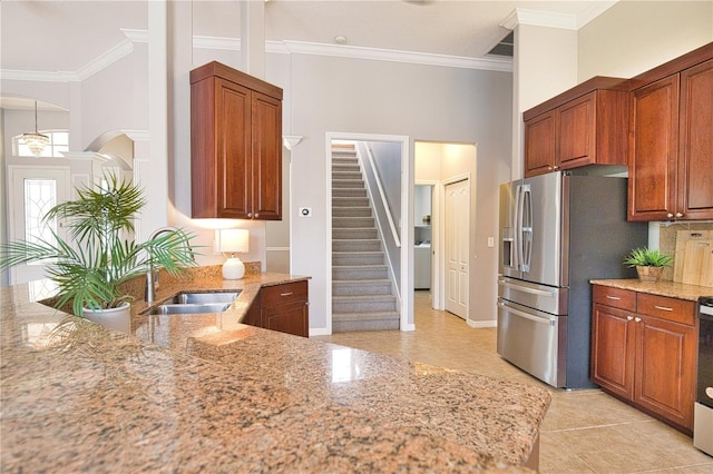 kitchen with ornamental molding, light stone countertops, and stainless steel refrigerator with ice dispenser