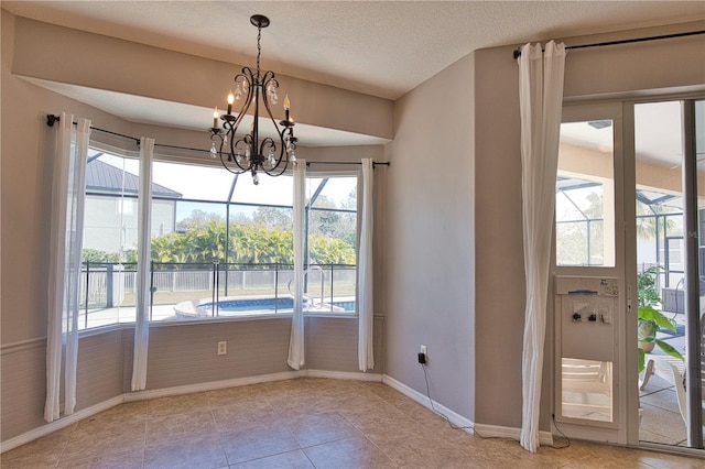 unfurnished dining area with an inviting chandelier, light tile patterned flooring, and a textured ceiling